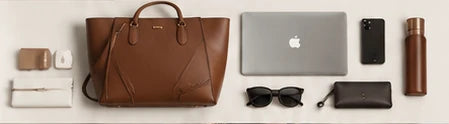 Illustration of a tote beside a laptop and daily essentials